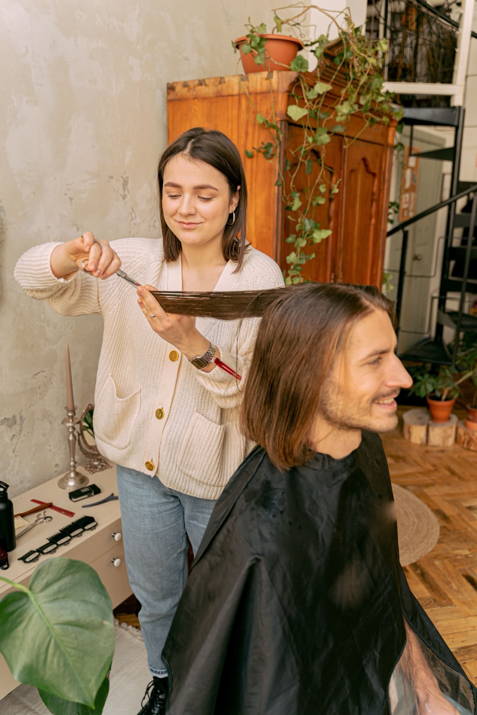 Barber mid-cut while an AI receptionist books the next appointment
