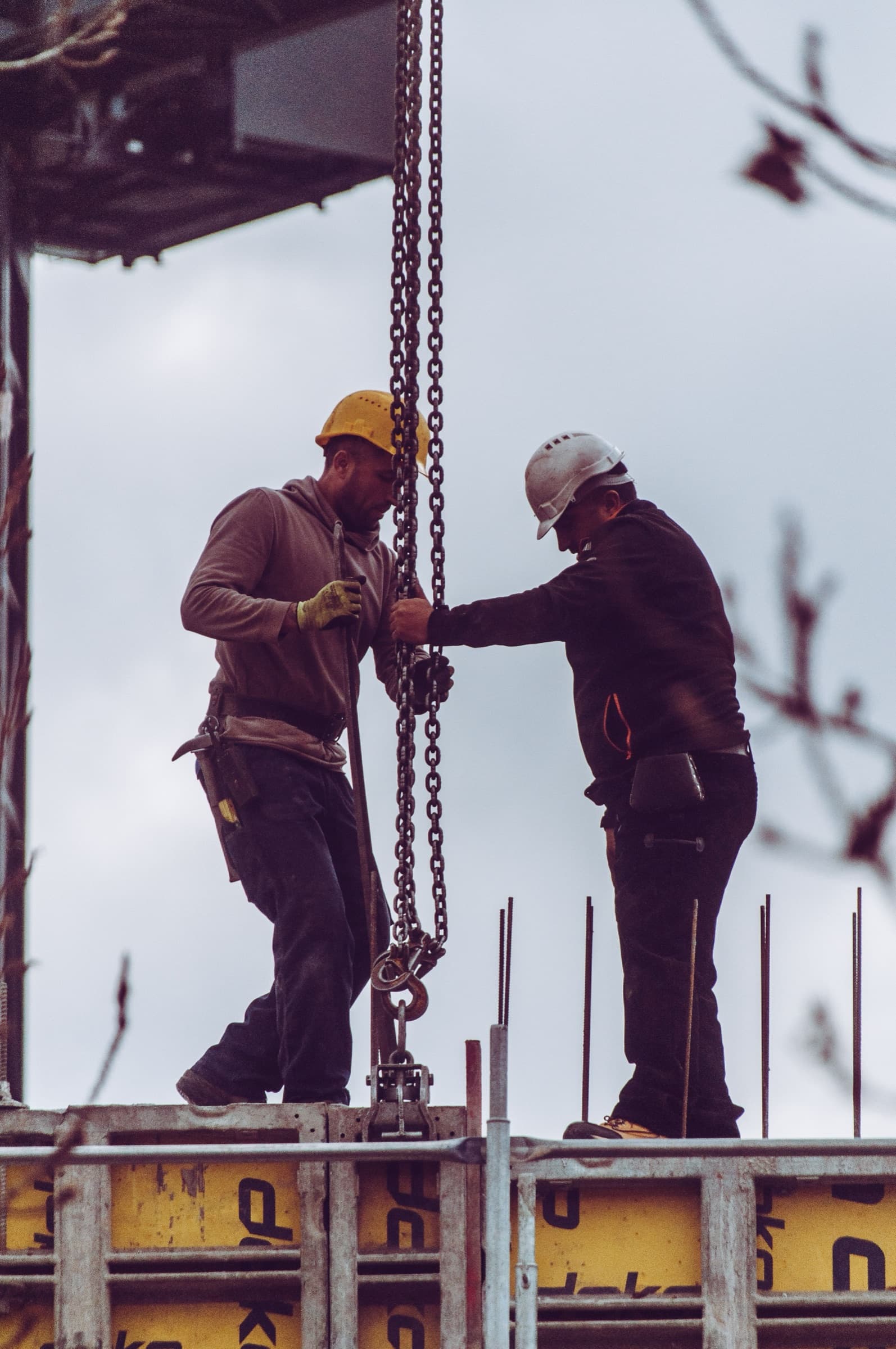 Contractor on a job site while an AI receptionist qualifies a project inquiry