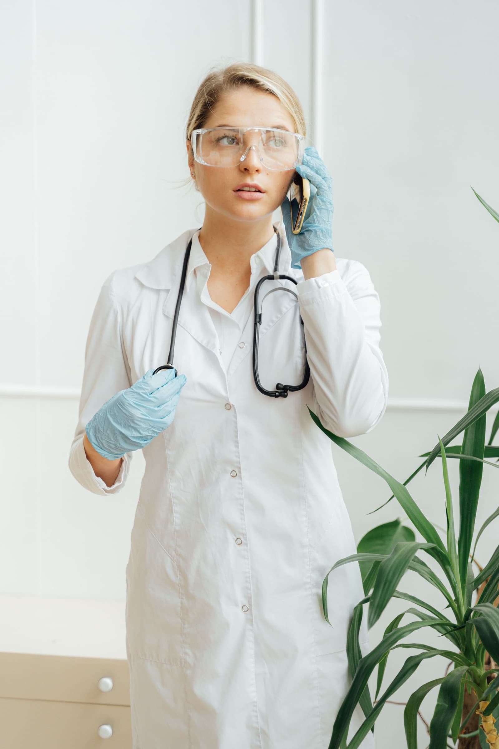 Physician with a patient while an AI receptionist schedules the next appointment