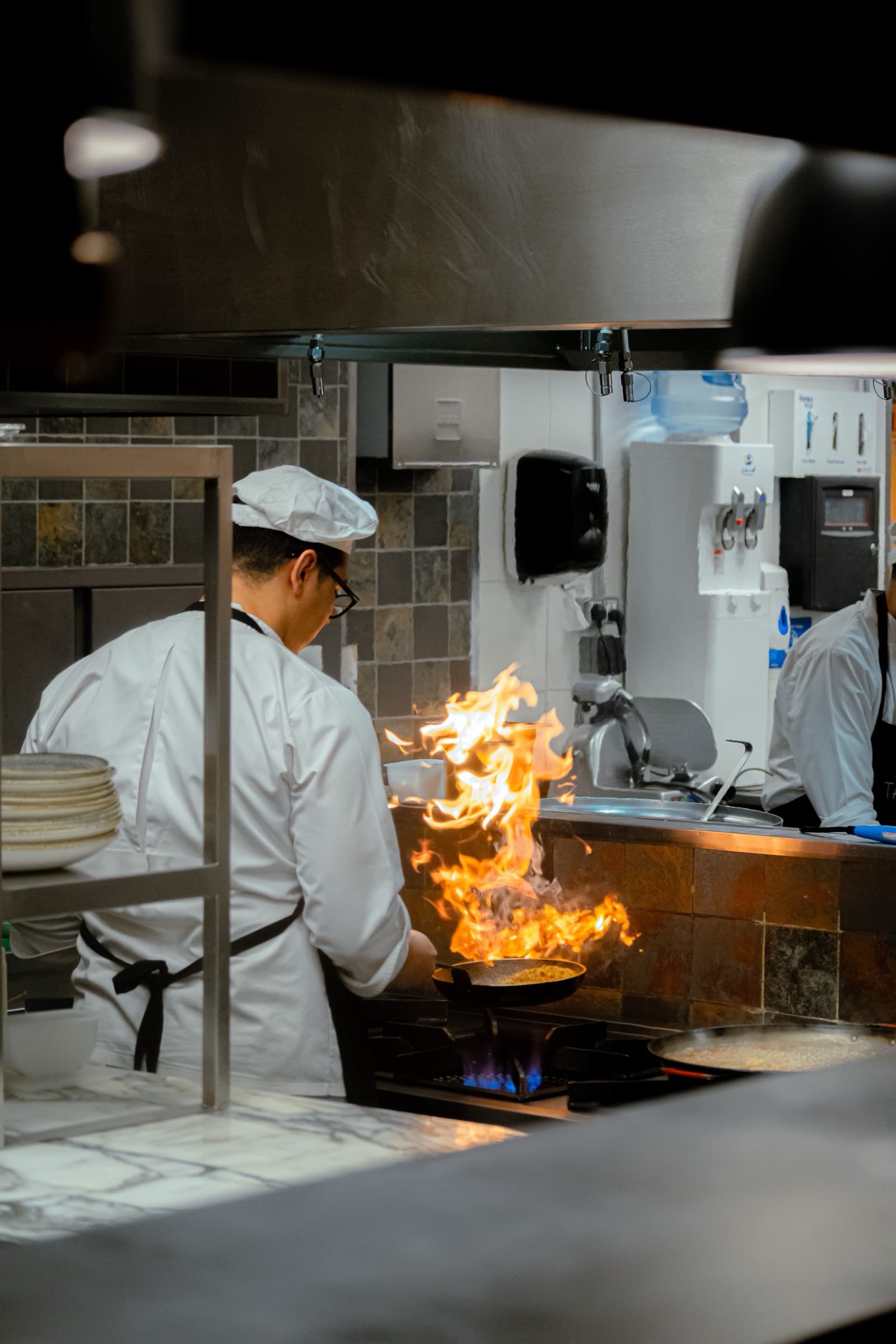 Chef during the dinner rush while an AI receptionist takes a reservation